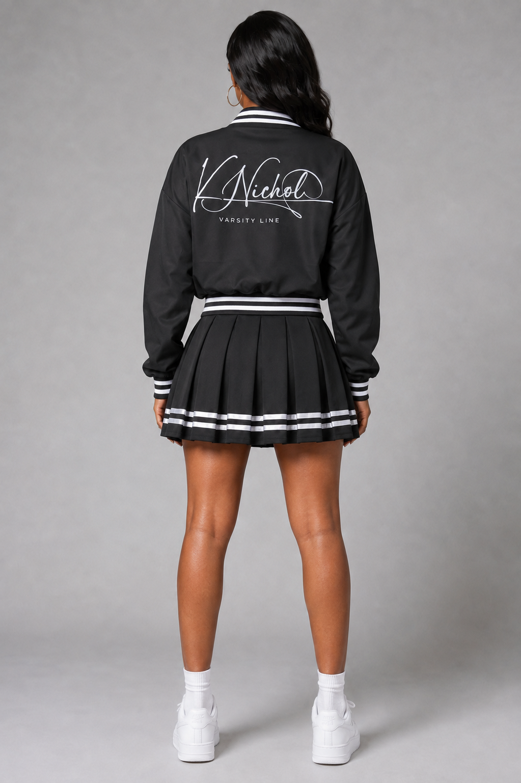 Back view of K Nichol Varsity Line jacket and skirt